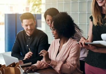 Diverse group of smiling business people working together in an office