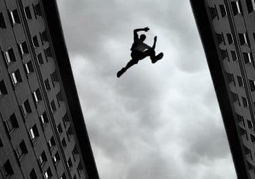 Man jumping over building